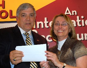 In November, Vic Budura, chapter president, presents a $1,000 check to Janice Luchner, robotics program sponsor, Columbia High School, who received the chapter's annual education award.
