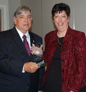 At the April meeting, Budura honors Christine Downing, outgoing program director, for her outstanding service to the chapter. Downing is the AFCEA International Meritorious Service award winner and the chapter's Special Appreciation award winner.