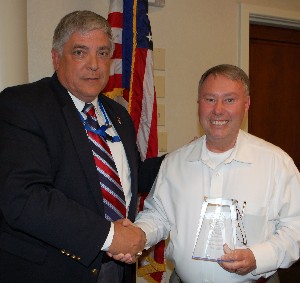 In May, Al Whitt (r), outgoing chapter treasurer, receives a token of appreciation from Budura. 