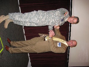 Col. Gregory B. Gonzalez, USA, program manager, Army UAS, receives an award from Terry Griffin, master of ceremonies, during the October symposium.