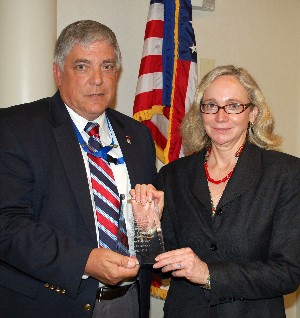 Budura presents Susan Campbell, outgoing chapter secretary, with a token of appreciation from the chapter at the May meeting.