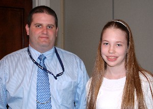 Rick Tuggle, chapter scholarship chairman, honors Bethany Johnson, a winner in the National Science Fair, a program supported by the chapter.