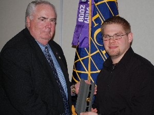 At the March meeting, Tom Gwaltney (l), regional vice president, presents Jim Marks with the chapter's Distinguished Young AFCEAN of the Year award.