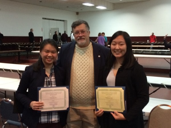 Accepting their awards for first place are Victoria Ge (l) and Madison Lee with Bob Whitkop, chapter president, at the annual Northeast Florida Regional Science and Engineering Fair in February. 