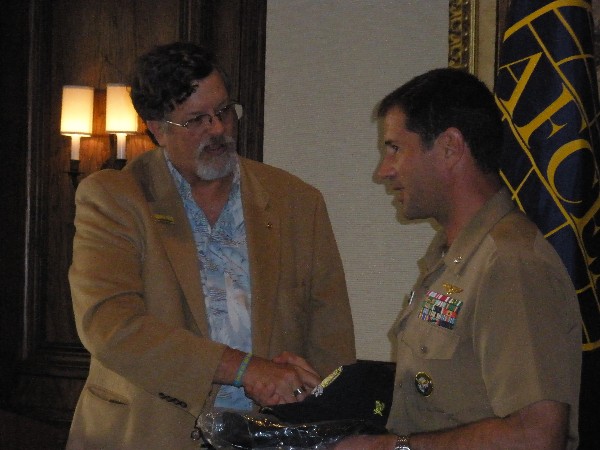Capt. Bob Whitkop, USN (Ret.), chapter president, presents mementos to Cmdr. Keats at the January luncheon in Jacksonville, Florida.