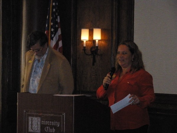 In January, Heidi Hughes, regional vice president, presents a check for the chapter's scholarship fund to Capt. Whitkop.