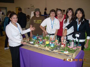 Carmen Polanco (c) and her chapter-sponsored Future City team from Dupont Middle School show their model of the City of 2290 at the regional Future City competition in Tampa in January.