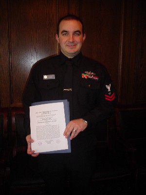 Michael Esch displays the certificate he recieved as recognition for being selected as Jacksonville's March Information Professional of the Month.