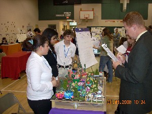 The Dupont Middle School team presents their city model to the judges at the January Future City regional competition. The team used the Sim City 3000 software program to develop their city of the future and build a model based on their solution, using recycled materials and less than $100. 