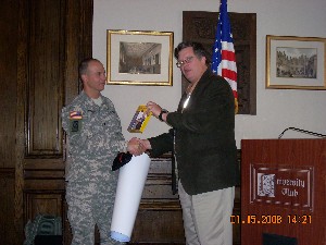Capt. Bob Whitkop, USN (Ret.), presents Col. Johnson with a memento for his January presentation to the chapter.