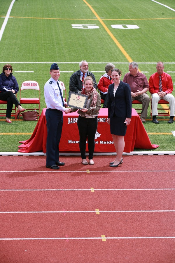 Chapter President Col. Jeffrey Sorrell, USAF (l), and Sherri Babylon of L-3 Communications (r) present a $6,000 science, technology, engineering and mathematics (STEM) scholarship to Anna Langholz of Kaiserslautern High School.