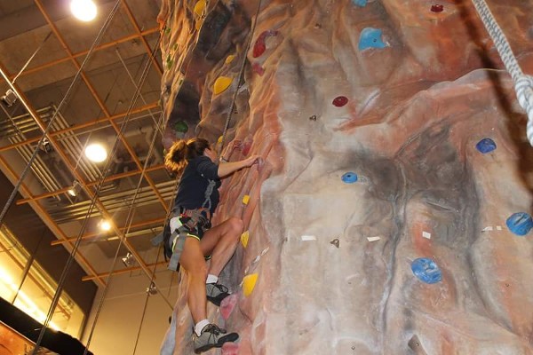 Capt. Angie Cox, USAF, leading the chapter's Young AFCEANs on their journey to the top of the Ramstein Outdoor Rec climbing wall in February. 