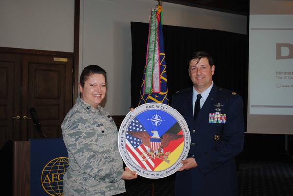 Chapter President Col. Robin Gibson, USAF, presents Capt. Matthew Streett, USAF, 86th Airlift Wing chaplain, with a gift for his dedication to the chapter during the May lunch.
