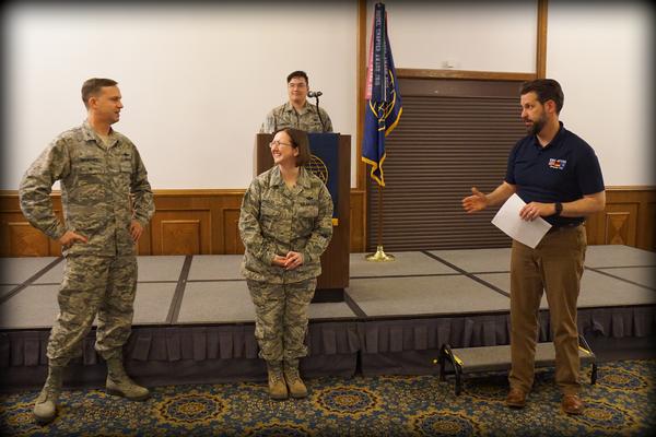 Col. Neal Bruegger, USAF, chapter president (l), and Master Sgt. Todd Weingeroff, USAF, chapter vice president, international affairs, present the AFCEA International Meritorious Service Award to   Master Sgt. Amanda Bradley, USAF, in April.
