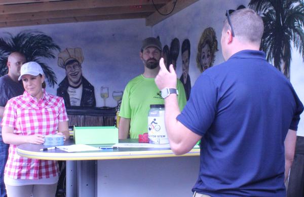 Welcoming attendees to the annual Young AFCEAN Summer Tech Expo Kickoff in July at the Belgian Bistro are (l-r) Tech. Sgt Kasey Mortillaro, USAF; Senior Airman Sidney Rodriguez, USAF; Todd Weingeroff; and Tech. Sgt. Thomas Giddings, USAF.