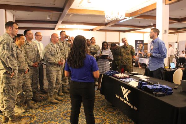Senior leaders tour the vendor floor during the Summer Tech Expo in July.