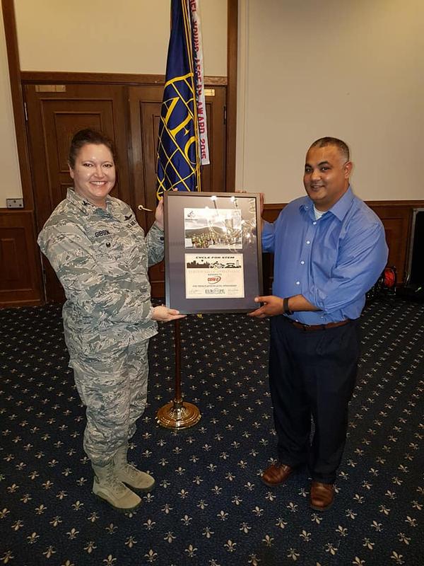 Col. Robin Gibson, USAF, chapter president, presents Rashmi Patel with a special award in December for his continued sponsorship and participation in the chapter's annual Cycle 4 STEM fundraiser.