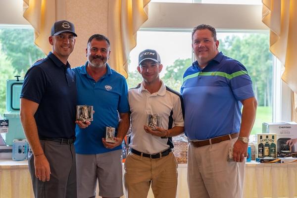 Winners of the "mentorship" foursome, which pairs senior executives with Young AFCEANs, are all smiles at the chapter's September golf tournament. Posing for a photo are (l-r) Philip Blanchard, golf committee co-chair for government, Don Gonsalves, William Nadeau and Kevin Donovan. 