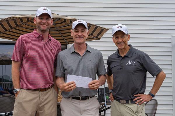 Flight 1 first place winners (l-r) Wes Denny, Kevin Sullivan and Brian Fredrickson are all smiles after beating the competition at the chapter's June golf tournament. Not pictured is Charles Lannan, the team's fourth. 