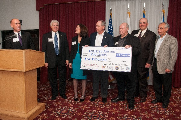 Bud Vazquez (l), chapter president, leads Hanscom Five Star organizations in presenting a donation to the Hanscom Air Force Base Enlisted Air Education Fund in November.