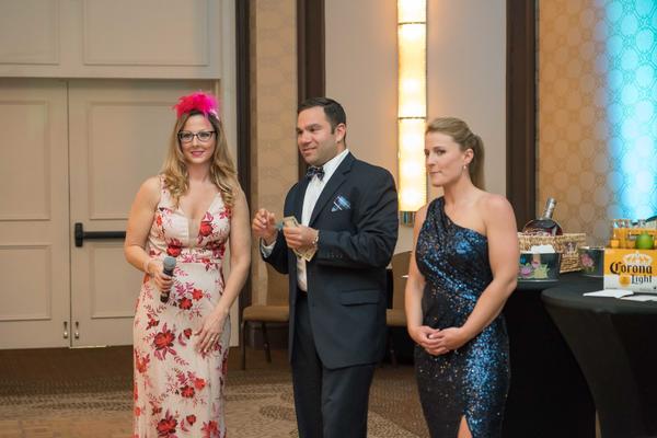 Announcing raffle prizes during the chapter's Spring Gala in May are Kim Matthews-Cranson, vice president of Young AFCEAN affairs (industry) (l), Matthew Deutsch, vice president of Young AFCEAN affairs (government) and Kate Stowe, chair, Spring Gala planning committee. All proceeds supported the chapter's education fund.