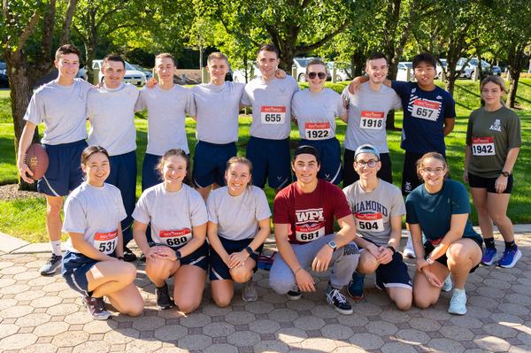 ROTC Cadets from Worcester Polytechnic Institute, the University of New Hampshire and the University of Massachusetts Lowell stretch before the September run.