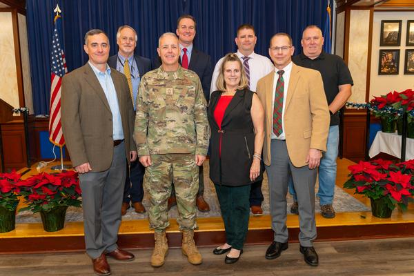 In December, the Distinguished Recipients of the Unsung Hero Awards are (l-r) Christopher Keeshan, Command, Control, Communications, Intelligence and Networks; Daniel Craig, Digital Directorate; Chief Master Sgt. Kevin Martin, Massachusetts National Guard Joint Force Headquarters; Kevin Kelleher, Contracting Directorate; Barbara Hiltz; Danny Picard, Nuclear Command, Control, and Communications Integration Directorate; David Hiltz; and Wiliam DeWare, 66th Air Base Group. 