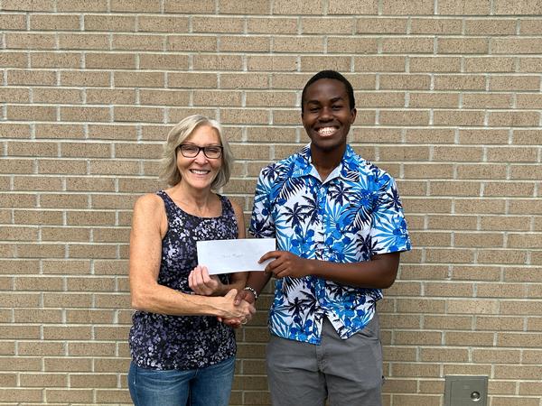 In September, Joyce Sidopoulos from MassRobotics presents a scholarship to Tevin Mbogo, South High Community School in Worcester, Massachusetts.