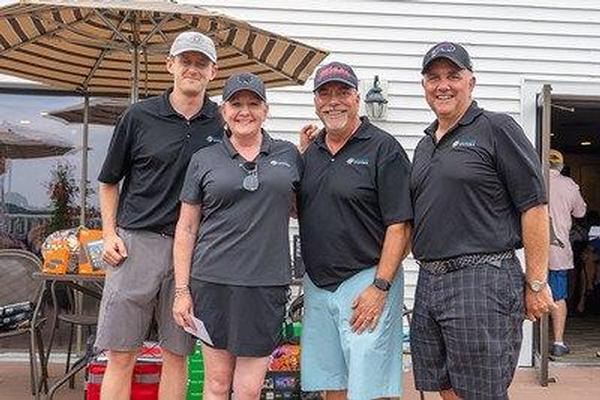 Flight 2 first place winners (l-r) Mike Magerman, Erin Donlan, Mike Petroskey and Tom Dubois pose for a group photo at the chapter's annual Elmer J. Fuller golf tournament in June.