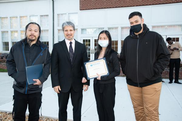 Jamie Thurber, chapter president (second l), congratulates Dan Choy (l), Pichraksmey Hoeu (second r) and Thomas Rua (far r), three of eight MCC students who received chapter STEM scholarships at a ceremony in mid-October on the school campus. 