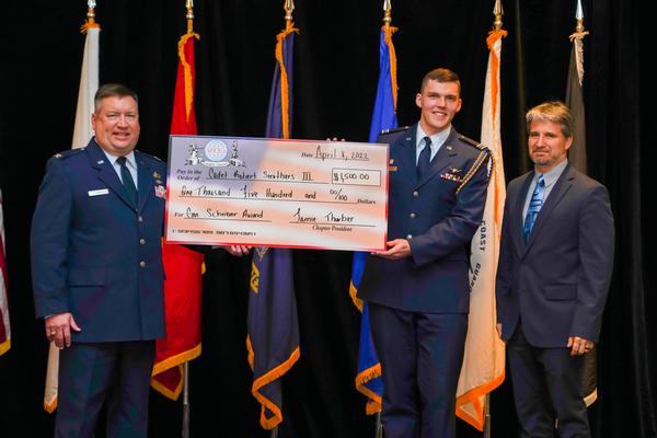 Col. Shane Louis, USAF, chapter vice president of ROTC Affairs (l), and Jamie Thurber, chapter president (far r), congratulate Cadet Smithers at the Luncheon in April.�
