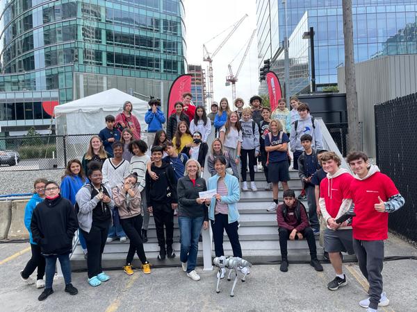 In October, Sidopoulos presents a $2,000 Grant to Huijing Wu, a teacher from the Eliot K-8 Innovation School, along with students from her 7th- and 8th-grade classes.