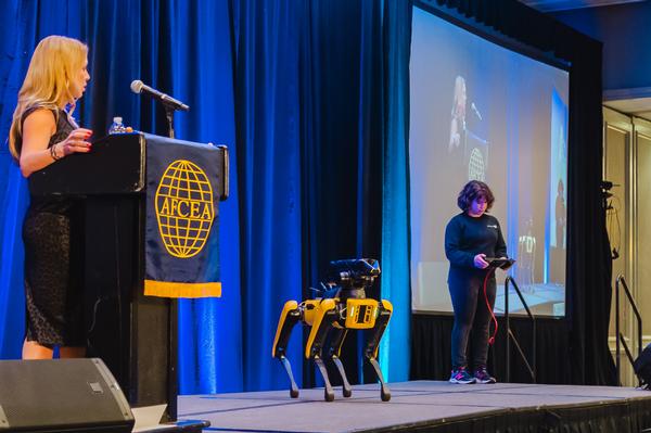 Kimberly Chamblin, director of partnerships, Public Sector (l) and Renee DiPrima Burns (r) demonstrate Spot from Boston Dynamics in March.
