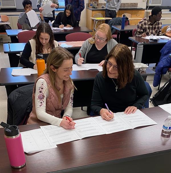 The chapter's Emerging Leaders grade the students' work at the MATHCOUNTS event in March.