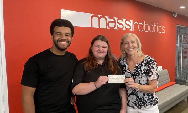 Khalif Mitchell, also from MassRobotics, and Sidopoulos present a scholarship to Jaiden Santos, University of Massachusetts-Lowell, in September.