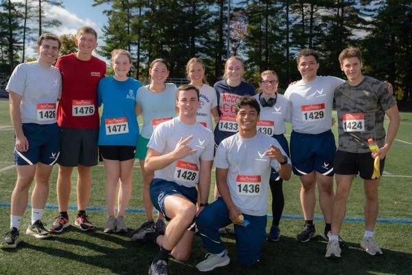 Happy runners have their numbers and pause for a photo before the October race.