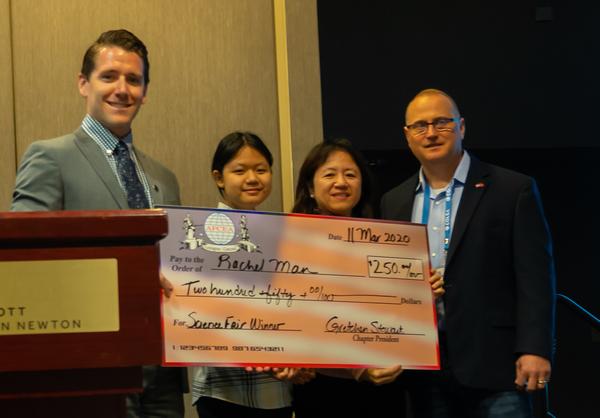 In March, Will Keller, Young AFCEAN president, industry, from Booz, Allen, Hamilton (l), congratulates Rachel Mann (center l) on winning her Lexington High School, Massachusetts, science fair this year with her Medhelper robot, which verifies the identify and quantity of medication, uses laser radar to navigate and delivers medication to hospital rooms via radio frequency tags. Joining Keller for the photo opportunity is Rachel's mother, Shu Chu Chen (center r), and Troy Blanchard, master of ceremonies.