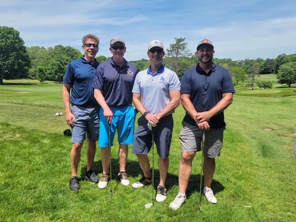 In June, Glen Townsend, Lt. Gen. Michael Schmidt, USAF, Col. Justin Collins, USAF, and Brian Kropa pose at the 12th hole before engaging in the Closest to the Pin challenge.