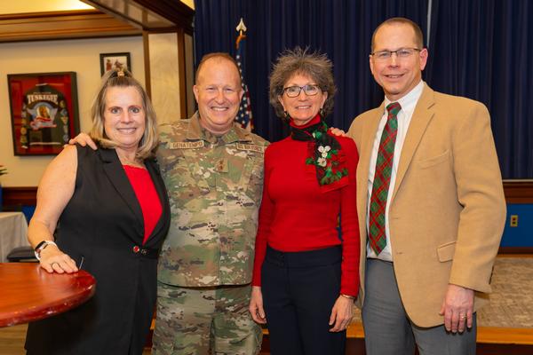 AFCEA's own David and Barbara Hiltz receive their award and are congratulated by Maj. Gen. Anthony Genatempo and Kathy Owens at the December ceremony.