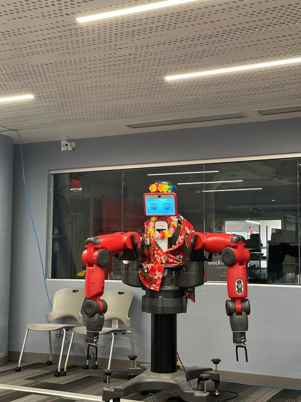 The best-looking robot deserves a Hawaiian lei and is given one during the July industry tour.