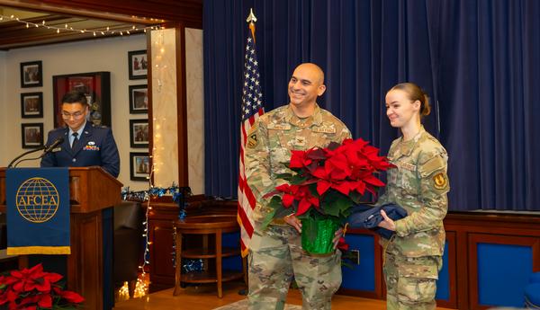In December, Staff Sgt. Virginia Barrack, 66th Air Base Group, commander support staff, receives her Unsung Hero's award from Col. Jorge Jimenez, commander, 66th Airbase Group.