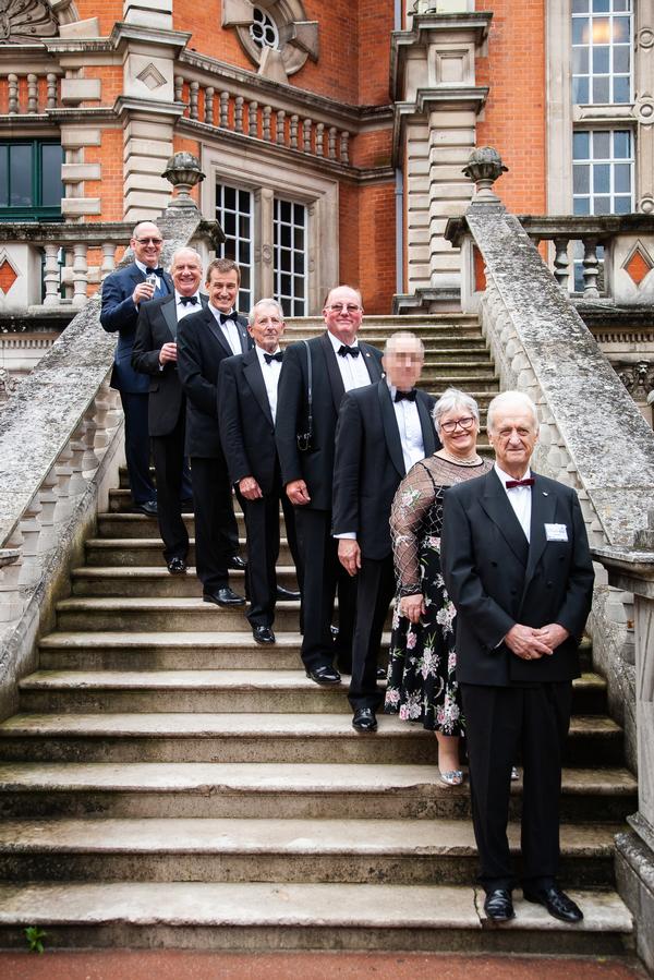 Some of the chapter's past presidents and past U.K. regional vice presidents paused for a photo with Air Commodore David Harrington, RAF (Ret.) (front right), at the June event.