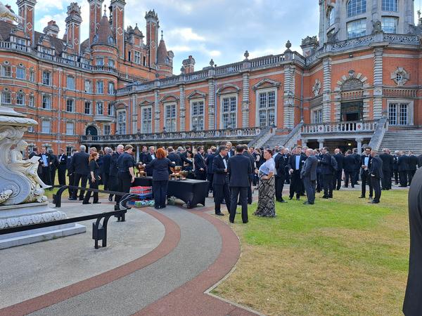 Guests enjoy a pre-dinner drinks reception in the South Quad at Royal Holloway, University of London, in June.