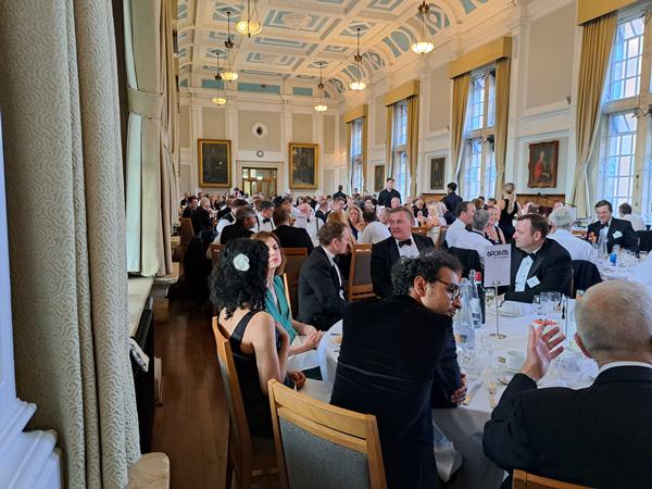 Guests enjoy dinner in the Founders' Dining Hall at Royal Holloway during the June celebration.