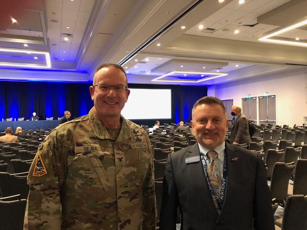 Brig. Gen. (S) Timothy Sejba, USAF, program executive officer, Space  Enterprise, and director, Enterprise Corps, Space Systems Command, pauses for a photo with Col. Scott Beidleman, USAF (Ret), at the October event.