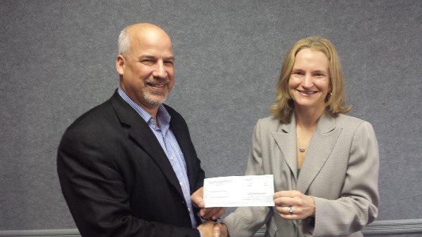 In March, Eileen Leonhardy from Rockwell Collins presents a check to Adam Feingold, chapter president.   