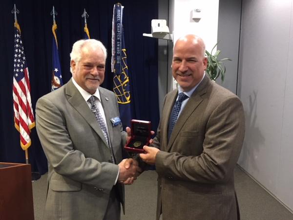 Chapter Past President Adam Feingold (r) receives the AFCEA Leadership Award from AFCEA Regional Vice President Douglas Holker at the July chapter meeting.