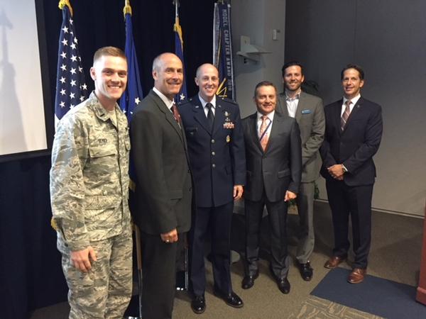 Pausing for a photo with August guest speaker Jim Reynolds, USAF, senior materiel leader of the Advanced Systems Division, Space Superiority Systems Directorate, Space and Missile Systems Center (SMC), Los Angeles (2nd from l), are (from l) Lt. Alexander Berry, USAF; Bill Page, chapter president; Scott Beidleman, vice president, programs; Nick Farinacci, vice president, operations; and Mike Plantenga, secretary. 