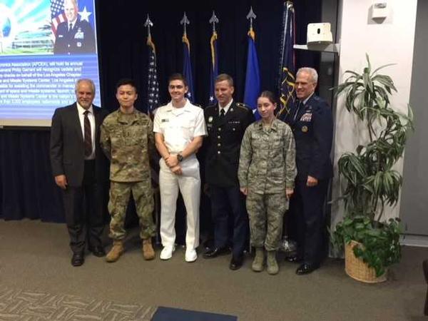 Douglas Holker, AFCEA regional vice president (l), and Brig. Gen. Philip Garrant, USAF, vice commander, Space and Missile Systems Center, Los Angeles Air Force Base (r), present chapter scholarships in September to local ROTC cadets and midshipmen, including (from l) Cadet Joe Nguyen, Midshipman David Sniffin, Cadet Gabriel Feingold and Cadet Kristen Peet. Scholarship recipient Cadet Adam Ha is not pictured. 