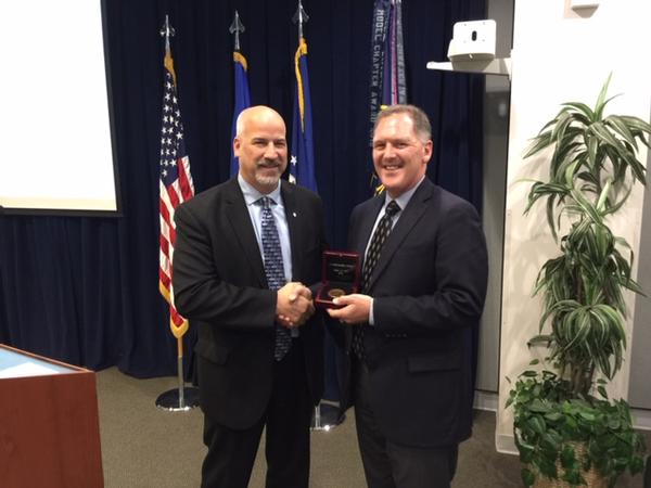 Lane Gilchrist, Alpha Omega Group, Space and Missile Systems Center (SMC) (r), receives the Medal of Merit from Regional Vice President Adam Feingold in June.